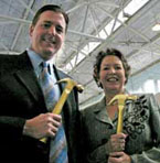 a man and a woman holding hammers.