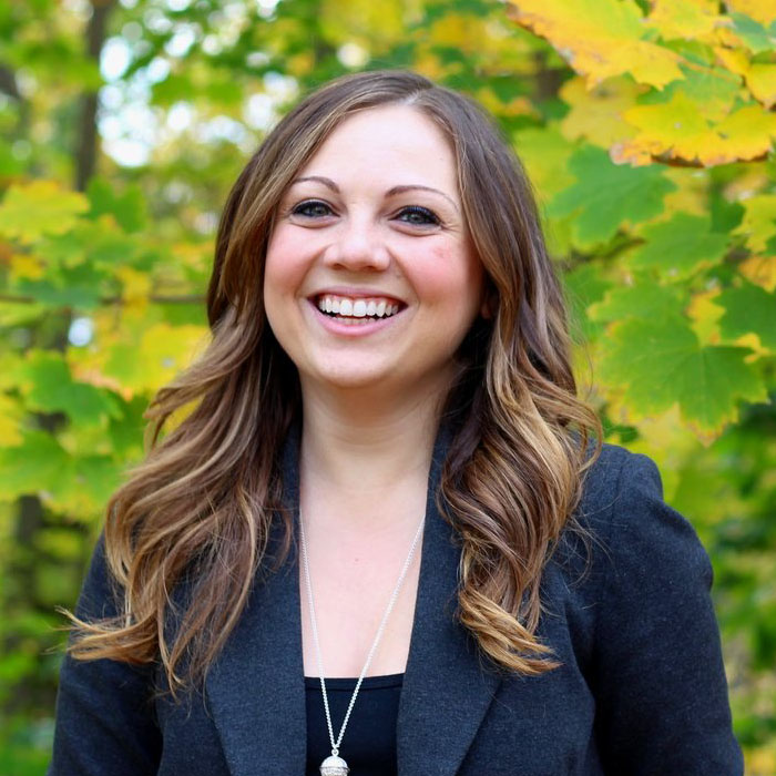 portrait of professional looking woman on a green background