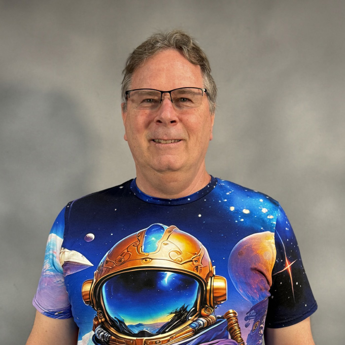 man wearing a shirt with planets on it
