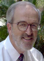  a man wearing glasses, smiling 